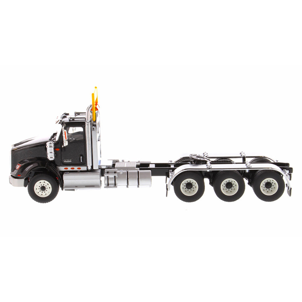 1:50 Scale Diecast Model of a Metallic Black International HX620 Tri-Axle Day Cab Tractor on a White Background