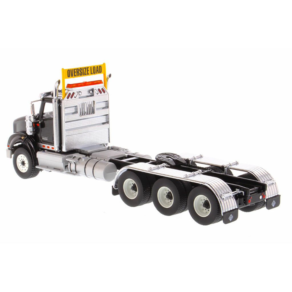 1:50 Scale Diecast Model of a Metallic Black International HX620 Tri-Axle Day Cab Tractor on a White Background