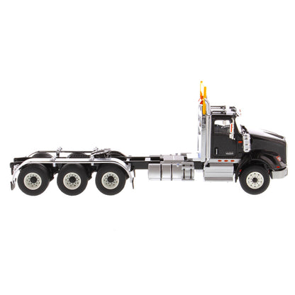 1:50 Scale Diecast Model of a Metallic Black International HX620 Tri-Axle Day Cab Tractor on a White Background
