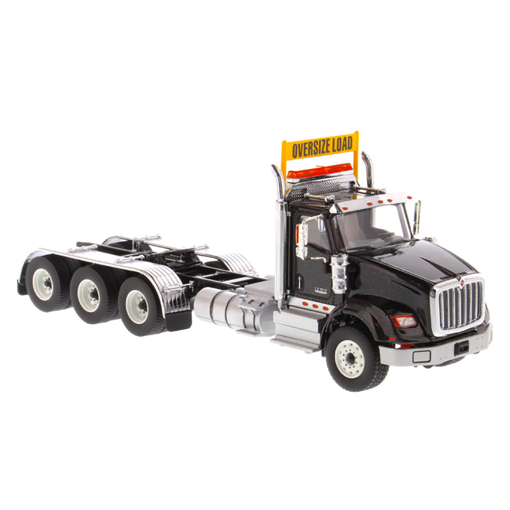 1:50 Scale Diecast Model of a Metallic Black International HX620 Tri-Axle Day Cab Tractor on a White Background