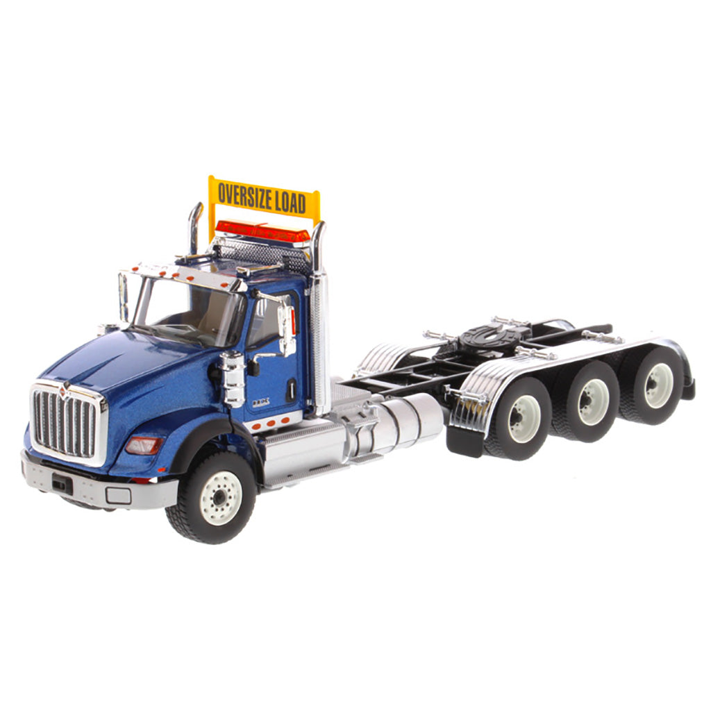 1:50 Scale Diecast Model of a Metallic Blue International HX620 Tri-Axle Day Cab Tractor on a White Background