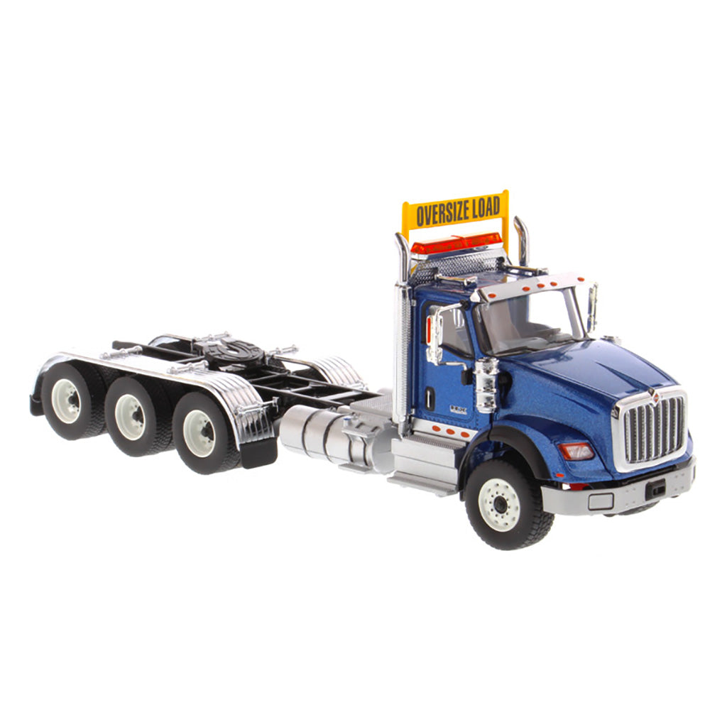 1:50 Scale Diecast Model of a Metallic Blue International HX620 Tri-Axle Day Cab Tractor on a White Background