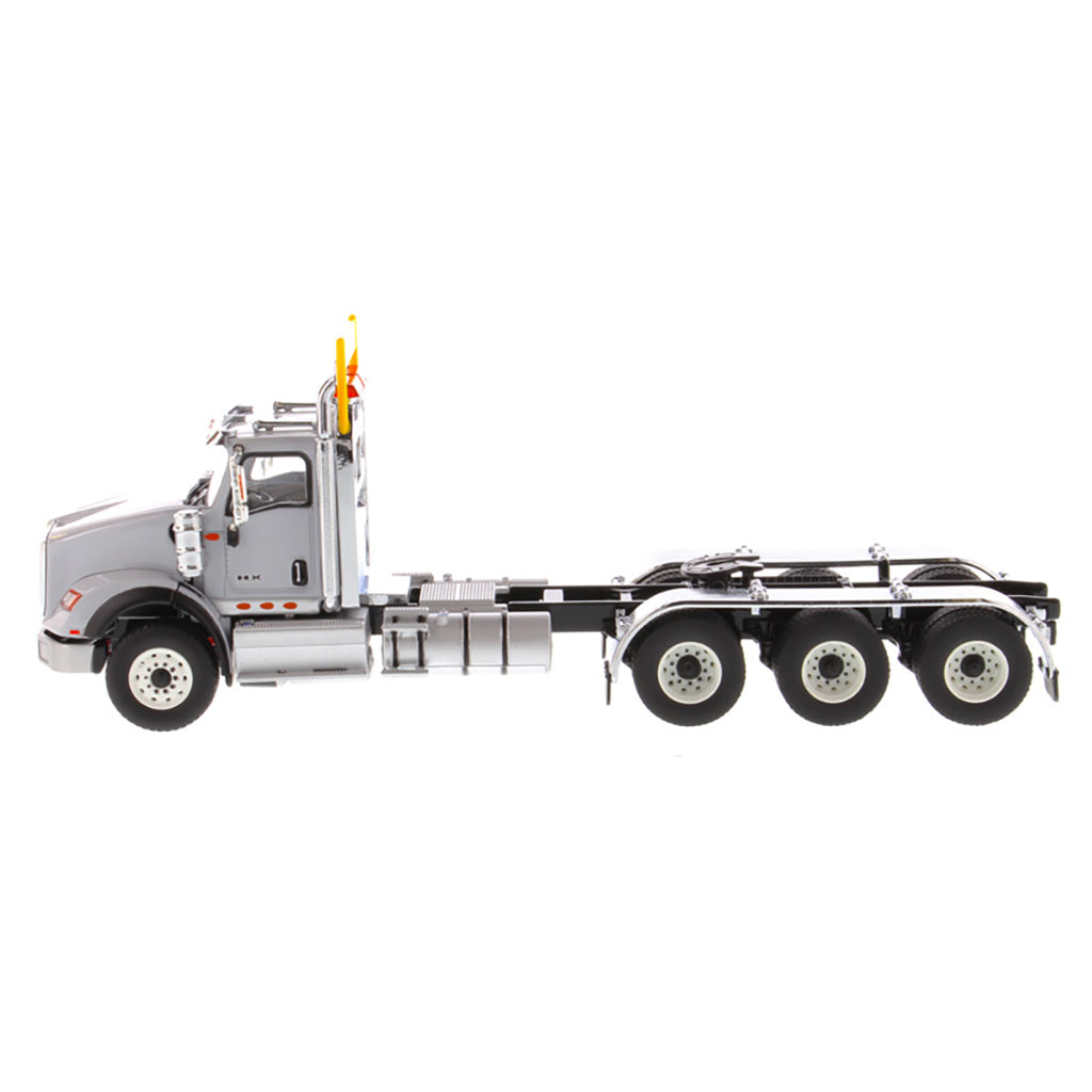 1:50 Scale Diecast Model of a Light Gray International HX620 Tri-Axle Day Cab Tractor on a White Background
