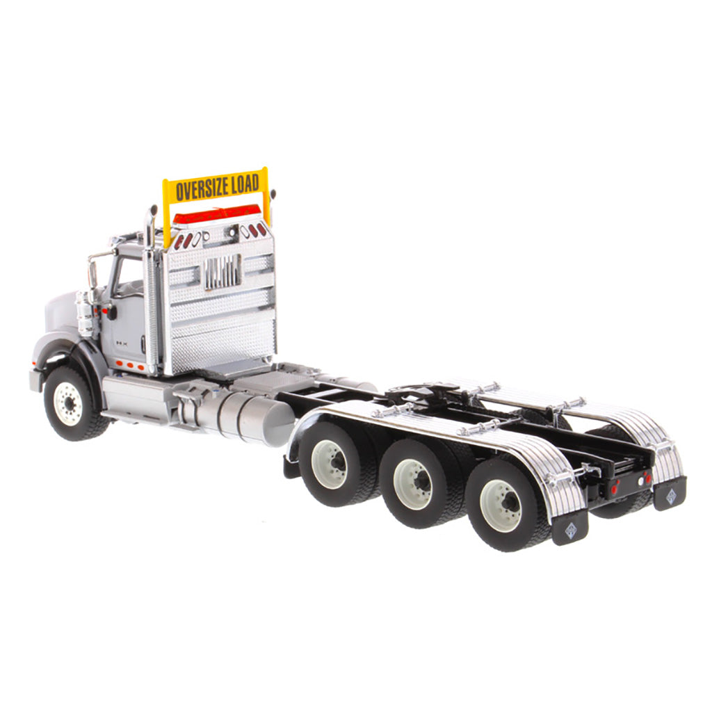 1:50 Scale Diecast Model of a Light Gray International HX620 Tri-Axle Day Cab Tractor on a White Background