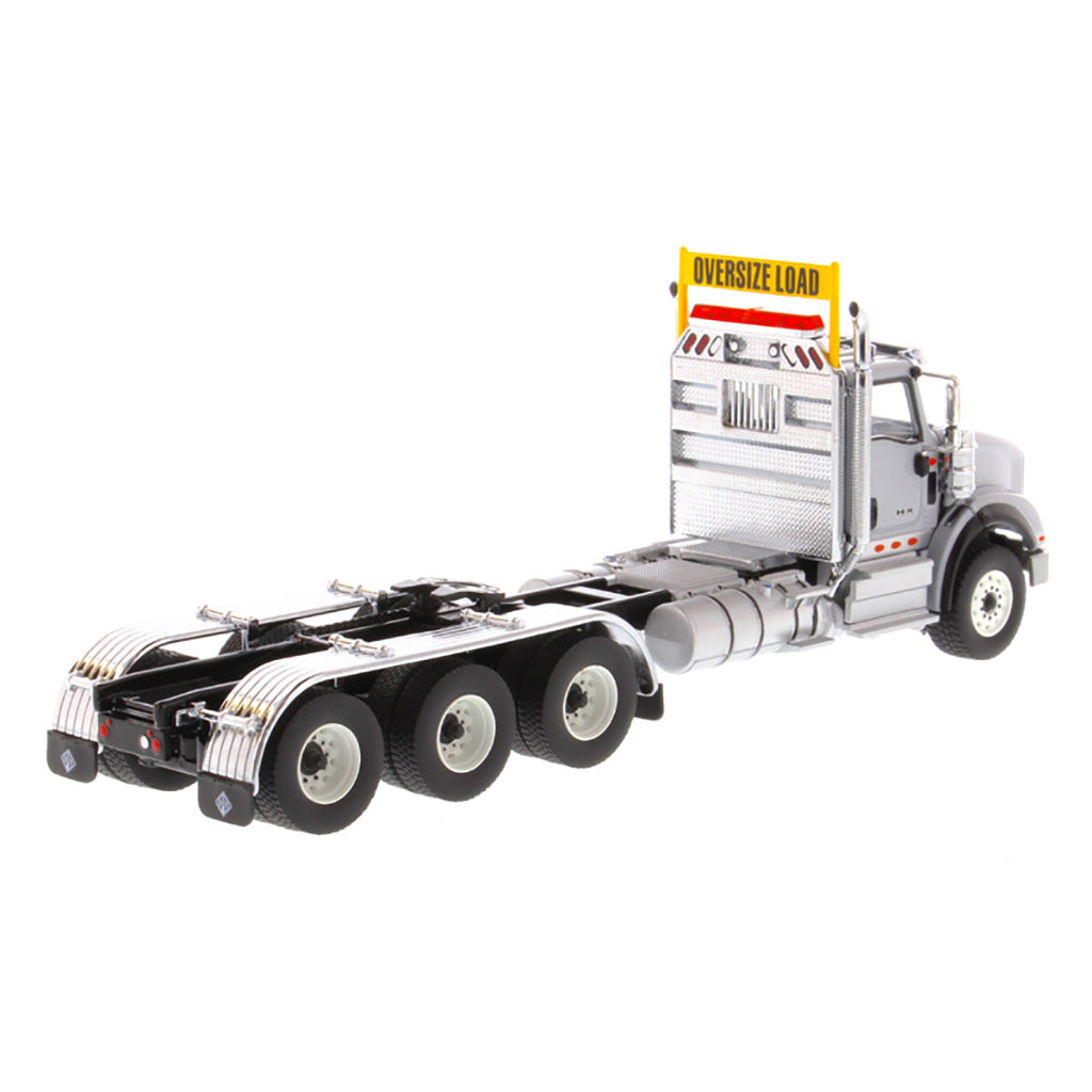 1:50 Scale Diecast Model of a Light Gray International HX620 Tri-Axle Day Cab Tractor on a White Background