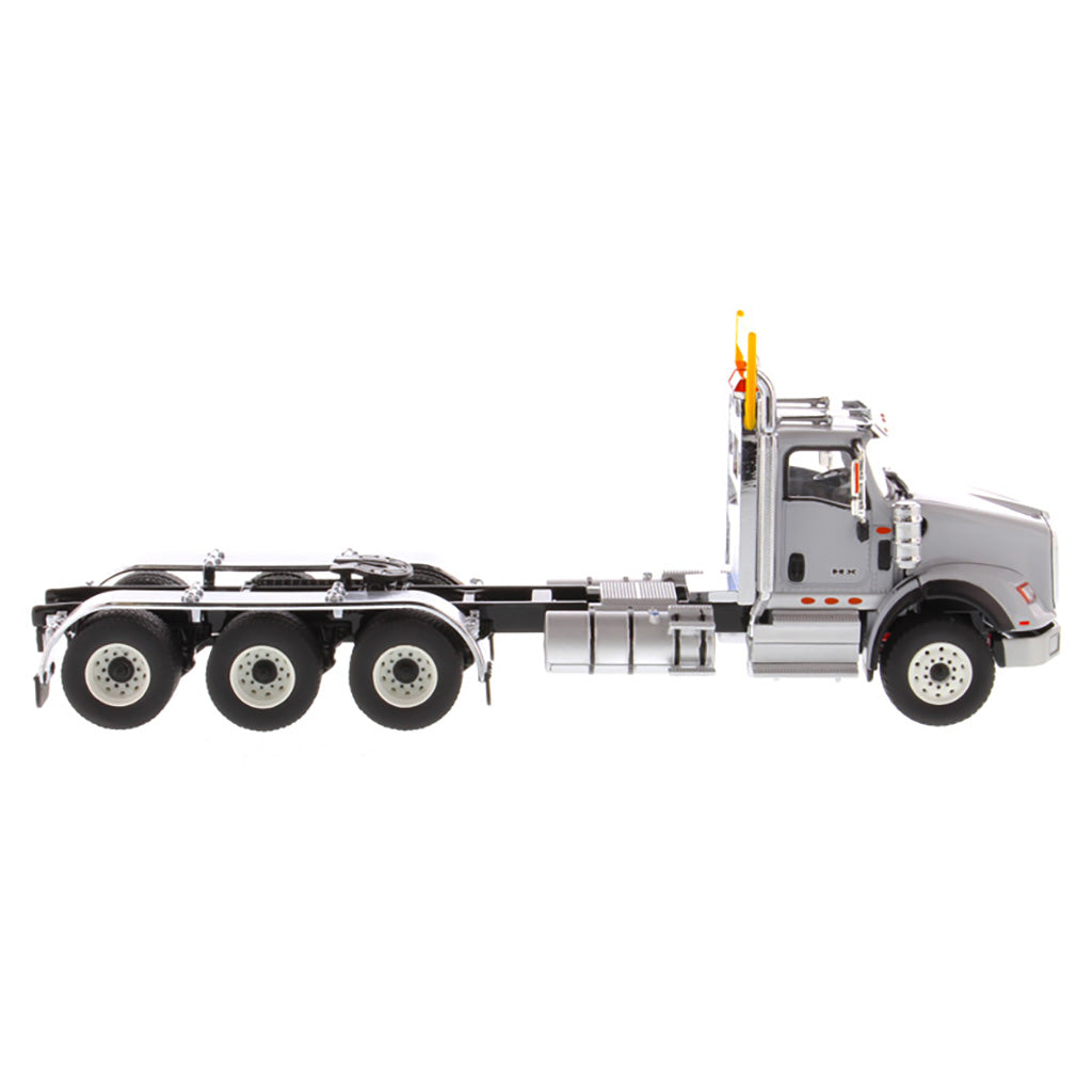1:50 Scale Diecast Model of a Light Gray International HX620 Tri-Axle Day Cab Tractor on a White Background