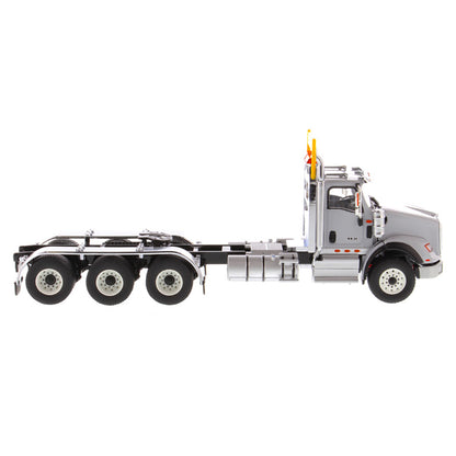 1:50 Scale Diecast Model of a Light Gray International HX620 Tri-Axle Day Cab Tractor on a White Background