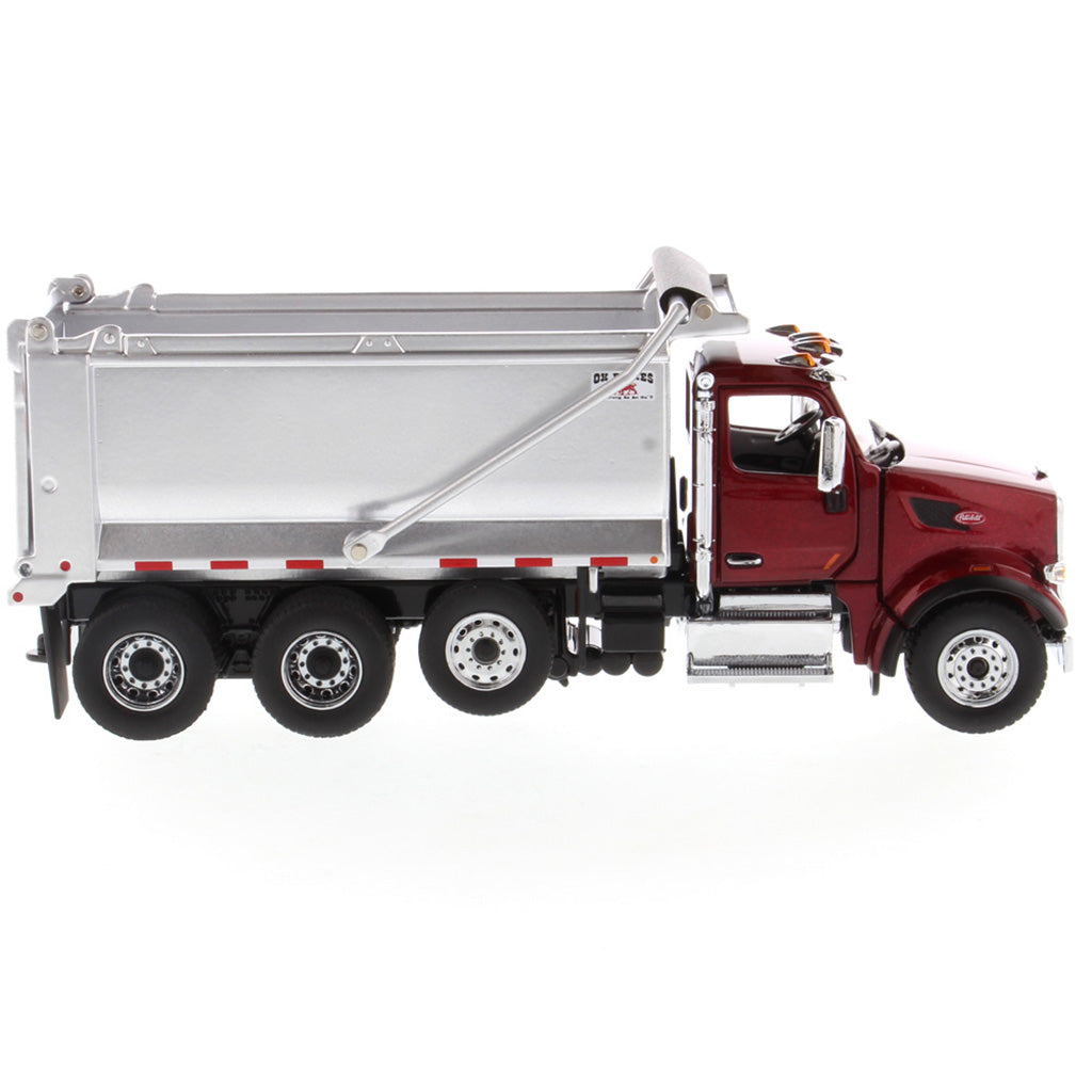 1:50th Scale Diecast Model of a Red & Silver Peterbilt Model 567 Dump Truck on a White Background