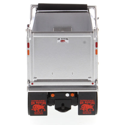 1:50th Scale Diecast Model of a Red & Silver Peterbilt Model 567 Dump Truck on a White Background
