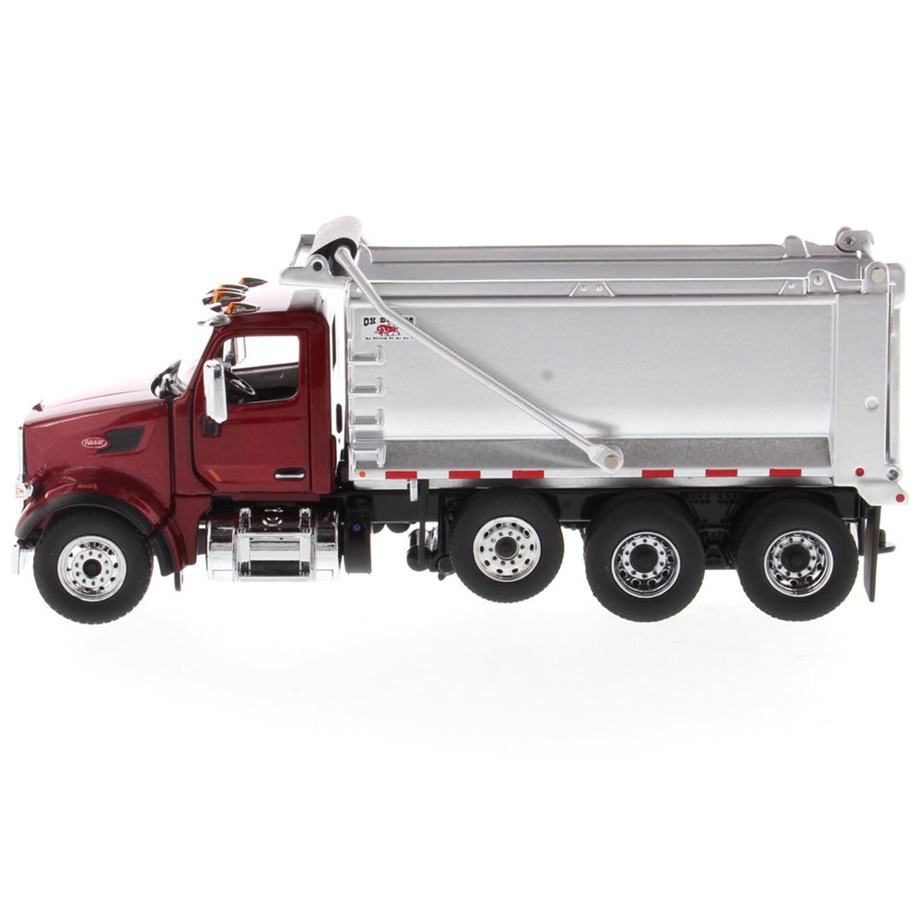 1:50th Scale Diecast Model of a Red & Silver Peterbilt Model 567 Dump Truck on a White Background