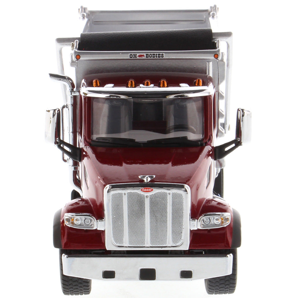 1:50th Scale Diecast Model of a Red & Silver Peterbilt Model 567 Dump Truck on a White Background