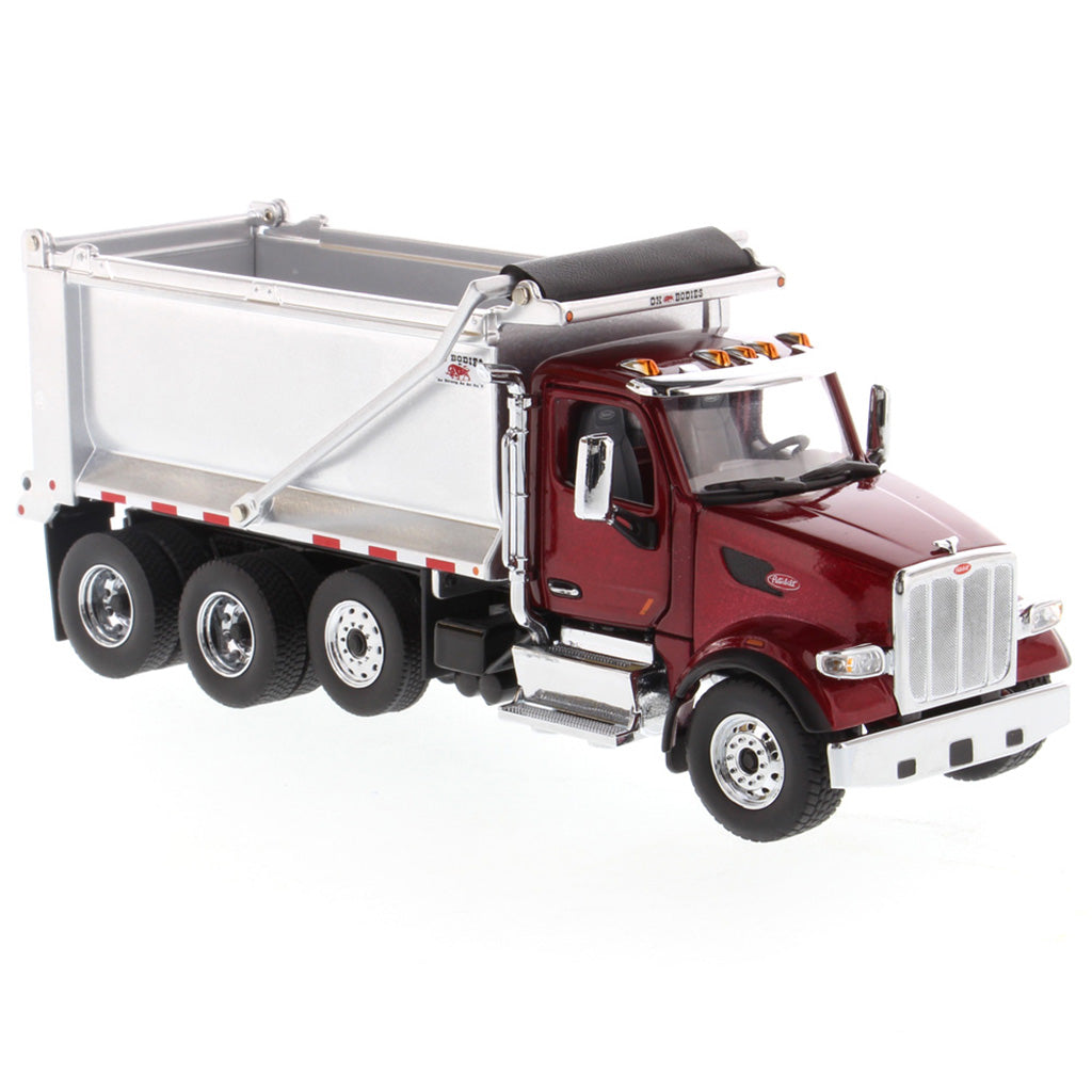 1:50th Scale Diecast Model of a Red & Silver Peterbilt Model 567 Dump Truck on a White Background