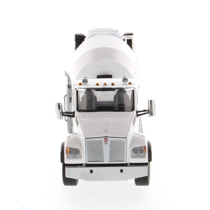 A white die-cast model of a Kenworth truck with a cement mixer drum, photographed on a seamless white background.