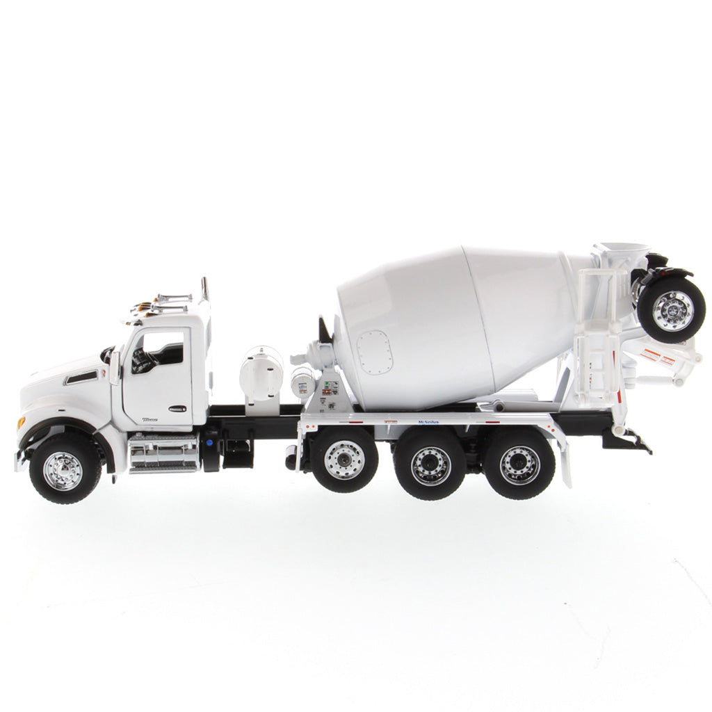 A white die-cast model of a Kenworth truck with a cement mixer drum, photographed on a seamless white background.