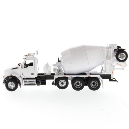 A white die-cast model of a Kenworth truck with a cement mixer drum, photographed on a seamless white background.