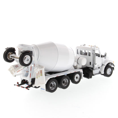 A white die-cast model of a Kenworth truck with a cement mixer drum, photographed on a seamless white background.