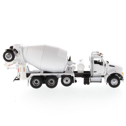 A white die-cast model of a Kenworth truck with a cement mixer drum, photographed on a seamless white background.