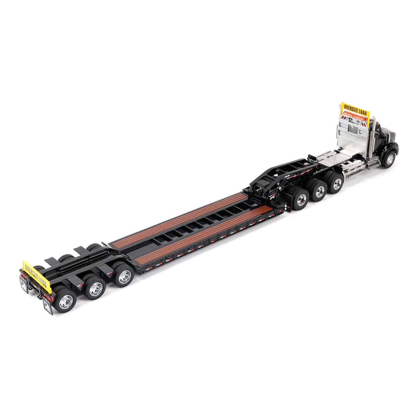 A detailed diecast model of a Kenworth T880 semi-truck towing a long black Trail King TK120 rgn lowboy trailer with a brown wood-look deck and yellow end caps, shown on a plain white background.
