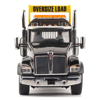 A detailed diecast model of a Kenworth T880 semi-truck towing a long black Trail King TK120 rgn lowboy trailer with a brown wood-look deck and yellow end caps, shown on a plain white background.