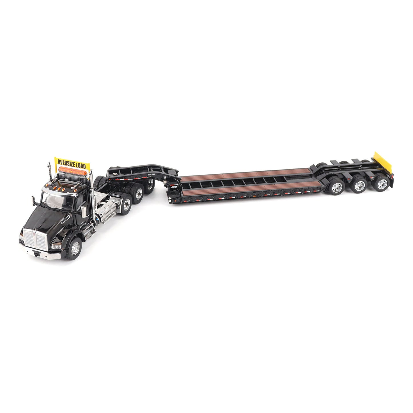 A detailed diecast model of a Kenworth T880 semi-truck towing a long black Trail King TK120 rgn lowboy trailer with a brown wood-look deck and yellow end caps, shown on a plain white background.