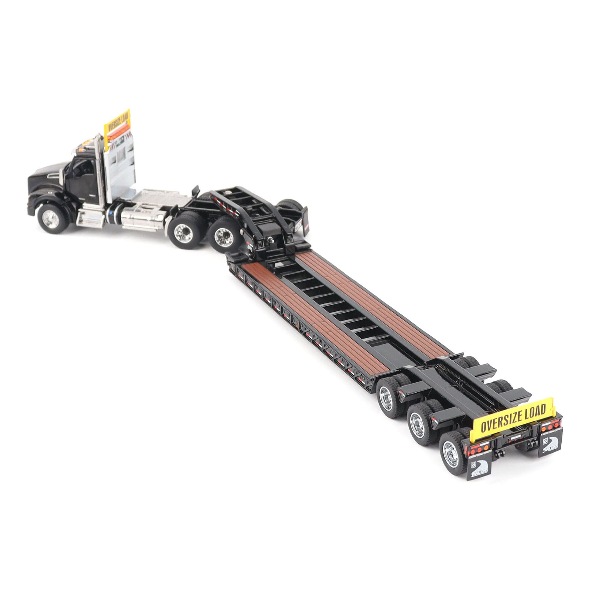 A detailed diecast model of a Kenworth T880 semi-truck towing a long black Trail King TK120 rgn lowboy trailer with a brown wood-look deck and yellow end caps, shown on a plain white background.