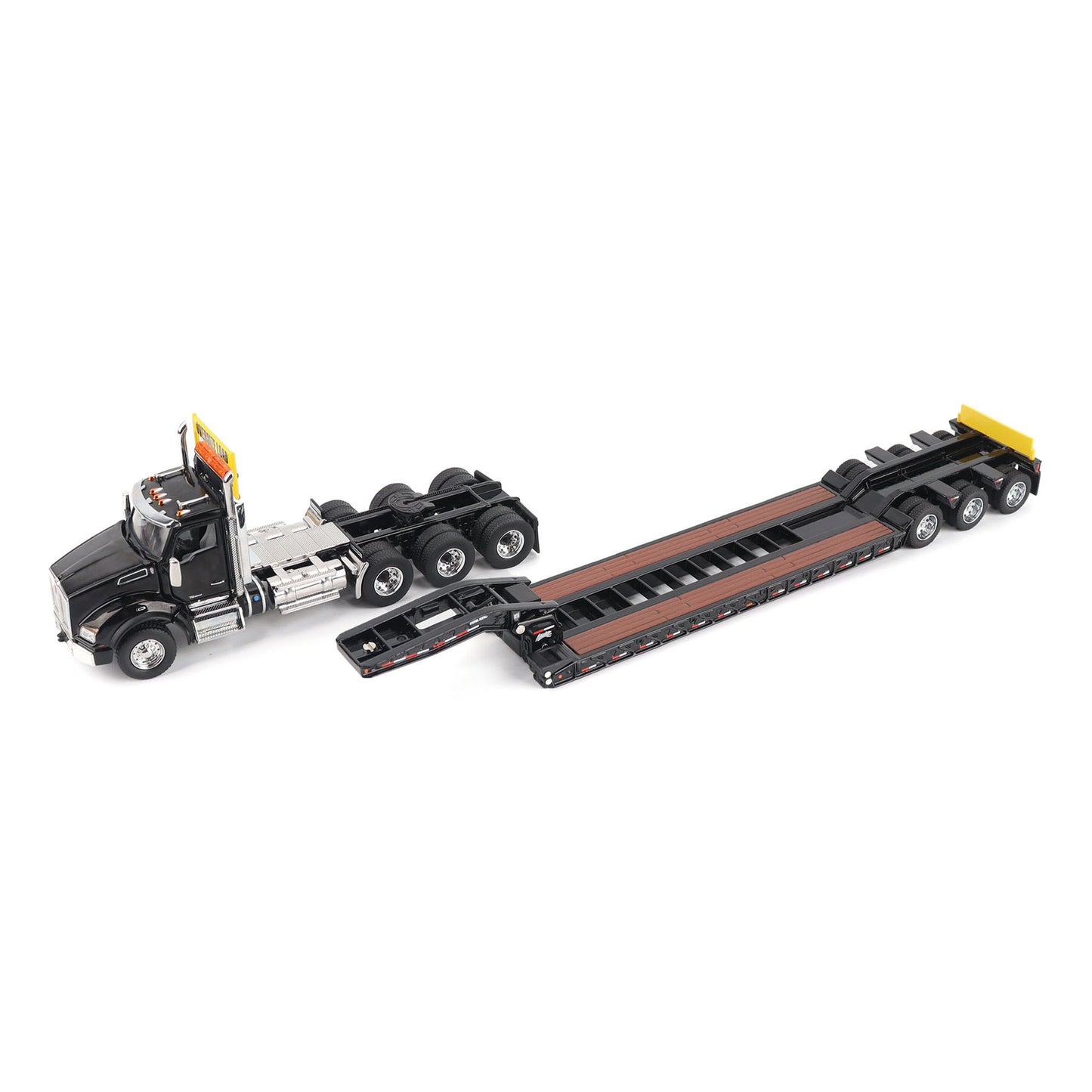 A detailed diecast model of a Kenworth T880 semi-truck towing a long black Trail King TK120 rgn lowboy trailer with a brown wood-look deck and yellow end caps, shown on a plain white background.