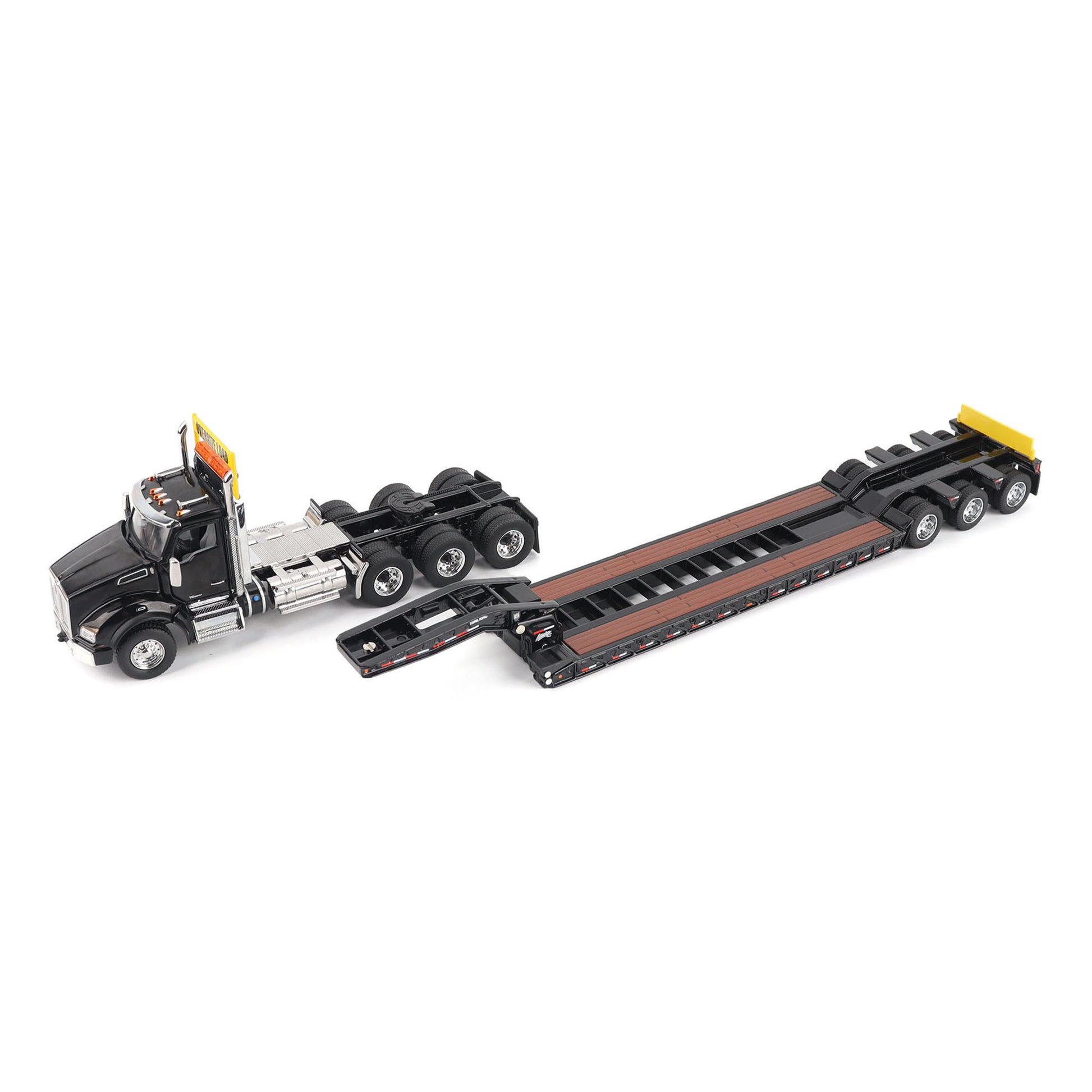 A detailed diecast model of a Kenworth T880 semi-truck towing a long black Trail King TK120 rgn lowboy trailer with a brown wood-look deck and yellow end caps, shown on a plain white background.