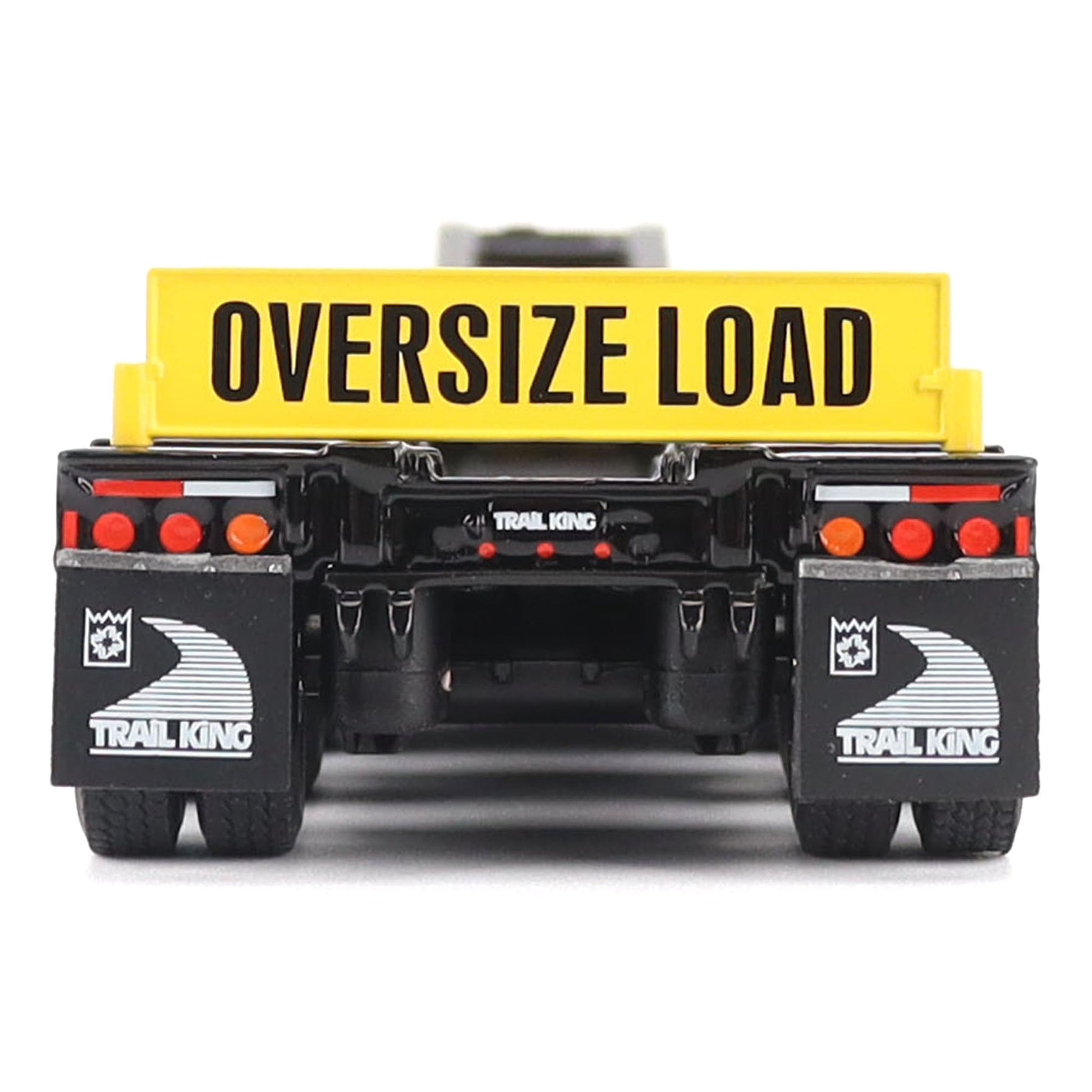 A toy model of a Trail King oversize load trailer, shown from the rear. The trailer features a bright yellow cargo box with 'OVERSIZE LOAD' printed in black, a black chassis, and black mudguards with white Trail King logos.