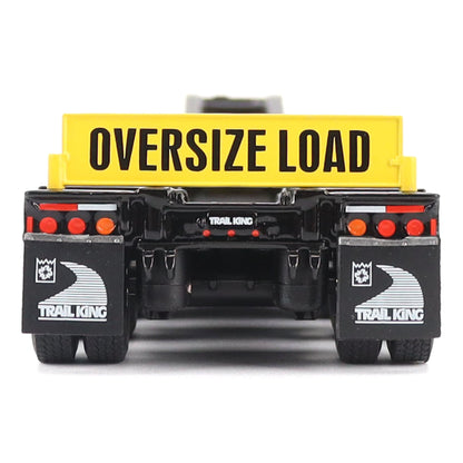 A toy model of a Trail King oversize load trailer, shown from the rear. The trailer features a bright yellow cargo box with 'OVERSIZE LOAD' printed in black, a black chassis, and black mudguards with white Trail King logos.