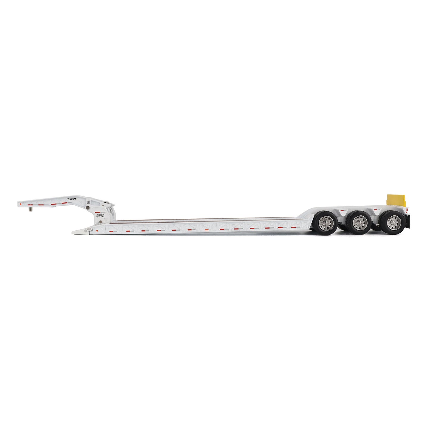 A miniature toy model of a Trail King TK120 lowboy trailer with a black frame, brown textured deck, and a yellow sign, shown on a solid white background.