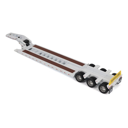 A miniature toy model of a Trail King TK120 lowboy trailer with a black frame, brown textured deck, and a yellow sign, shown on a solid white background.