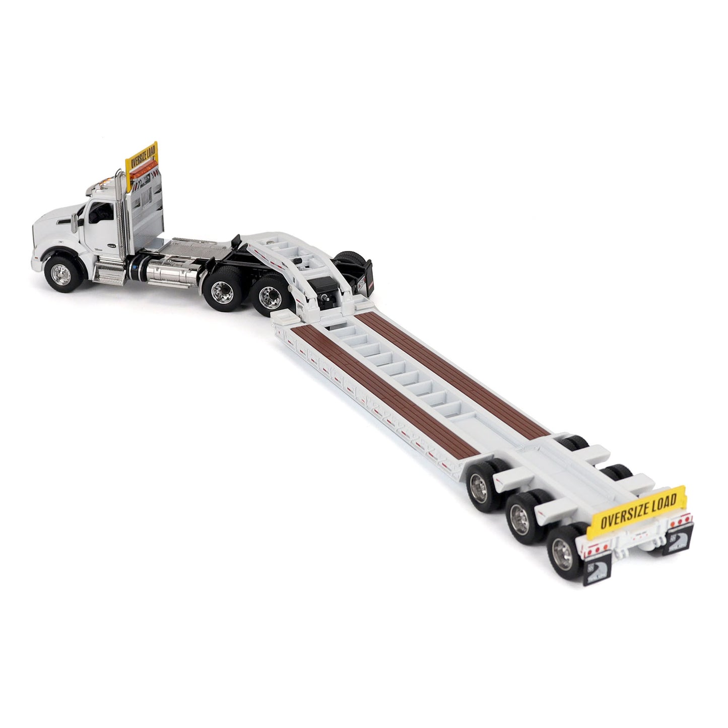 A detailed diecast model of a Kenworth T880 semi-truck towing a long black Trail King TK120 rgn lowboy trailer with a brown wood-look deck and yellow end caps, shown on a plain white background.