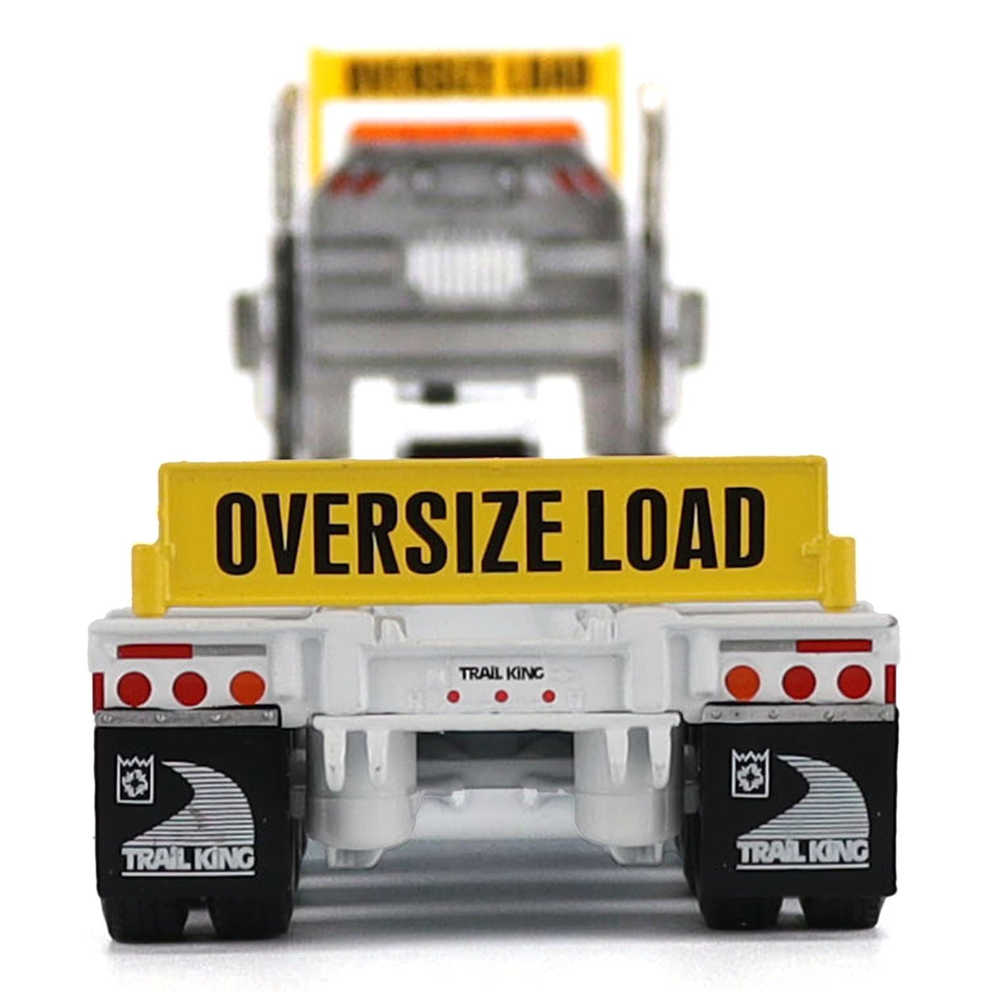 A detailed diecast model of a Kenworth T880 semi-truck towing a long black Trail King TK120 rgn lowboy trailer with a brown wood-look deck and yellow end caps, shown on a plain white background.