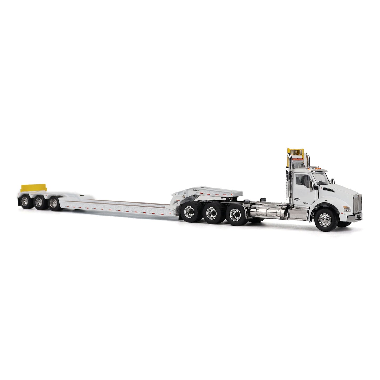 A detailed diecast model of a Kenworth T880 semi-truck towing a long black Trail King TK120 rgn lowboy trailer with a brown wood-look deck and yellow end caps, shown on a plain white background.