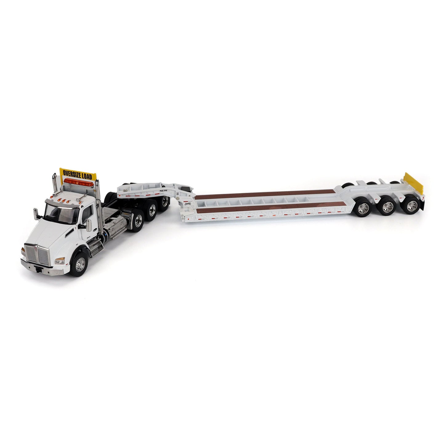 A detailed diecast model of a Kenworth T880 semi-truck towing a long black Trail King TK120 rgn lowboy trailer with a brown wood-look deck and yellow end caps, shown on a plain white background.