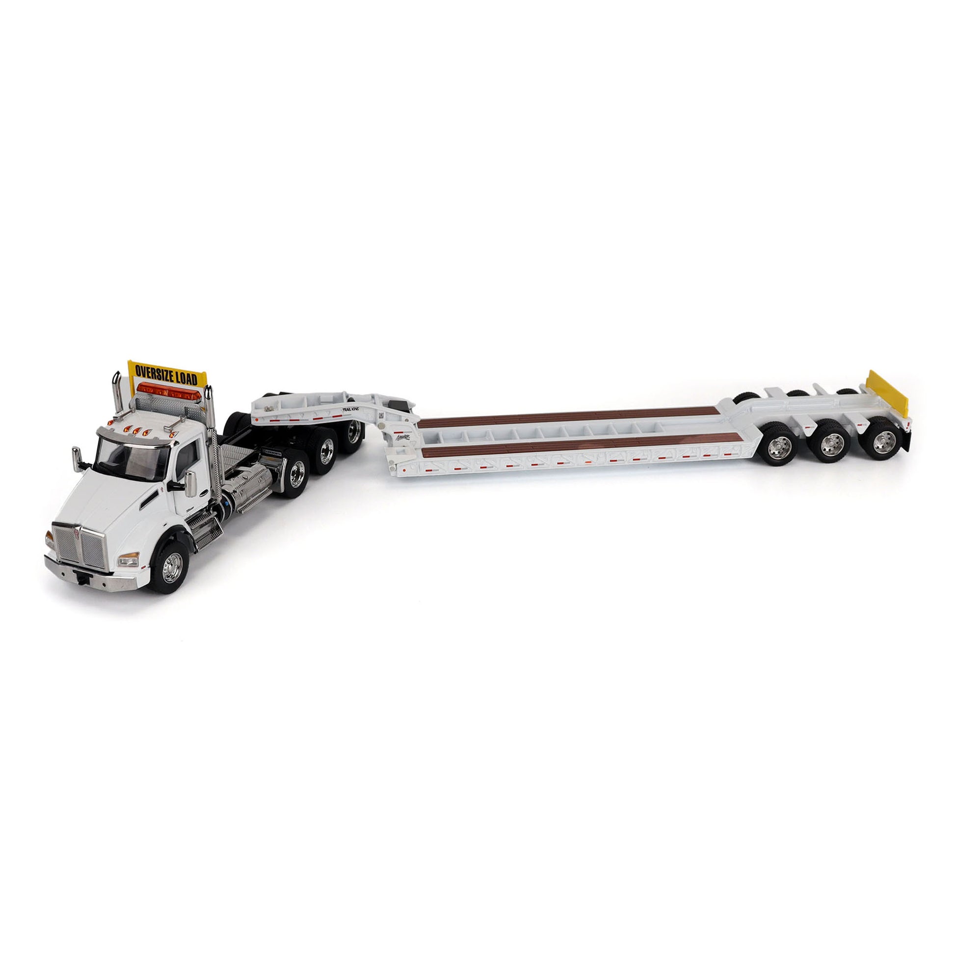 A detailed diecast model of a Kenworth T880 semi-truck towing a long black Trail King TK120 rgn lowboy trailer with a brown wood-look deck and yellow end caps, shown on a plain white background.
