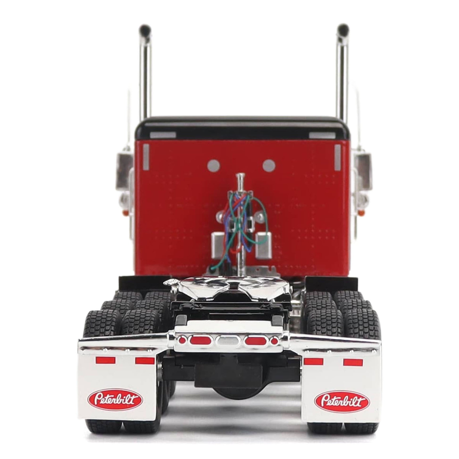 1:32nd Scale Diecast Model of a Peterbilt Model 589 in Legendary Red and Black Paint with Sleeper Compartment and Tri-Axle Configuration Photographed on a Clean White Background