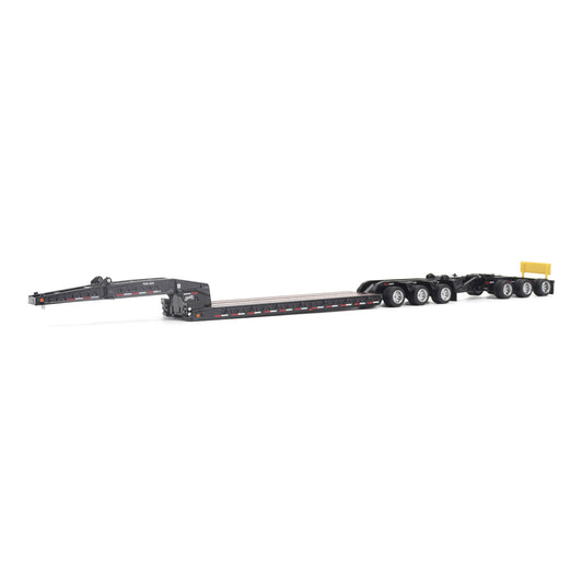 A miniature toy model of a Trail King TK120 lowboy trailer with a black frame, brown textured deck, and a yellow sign, shown on a solid white background.