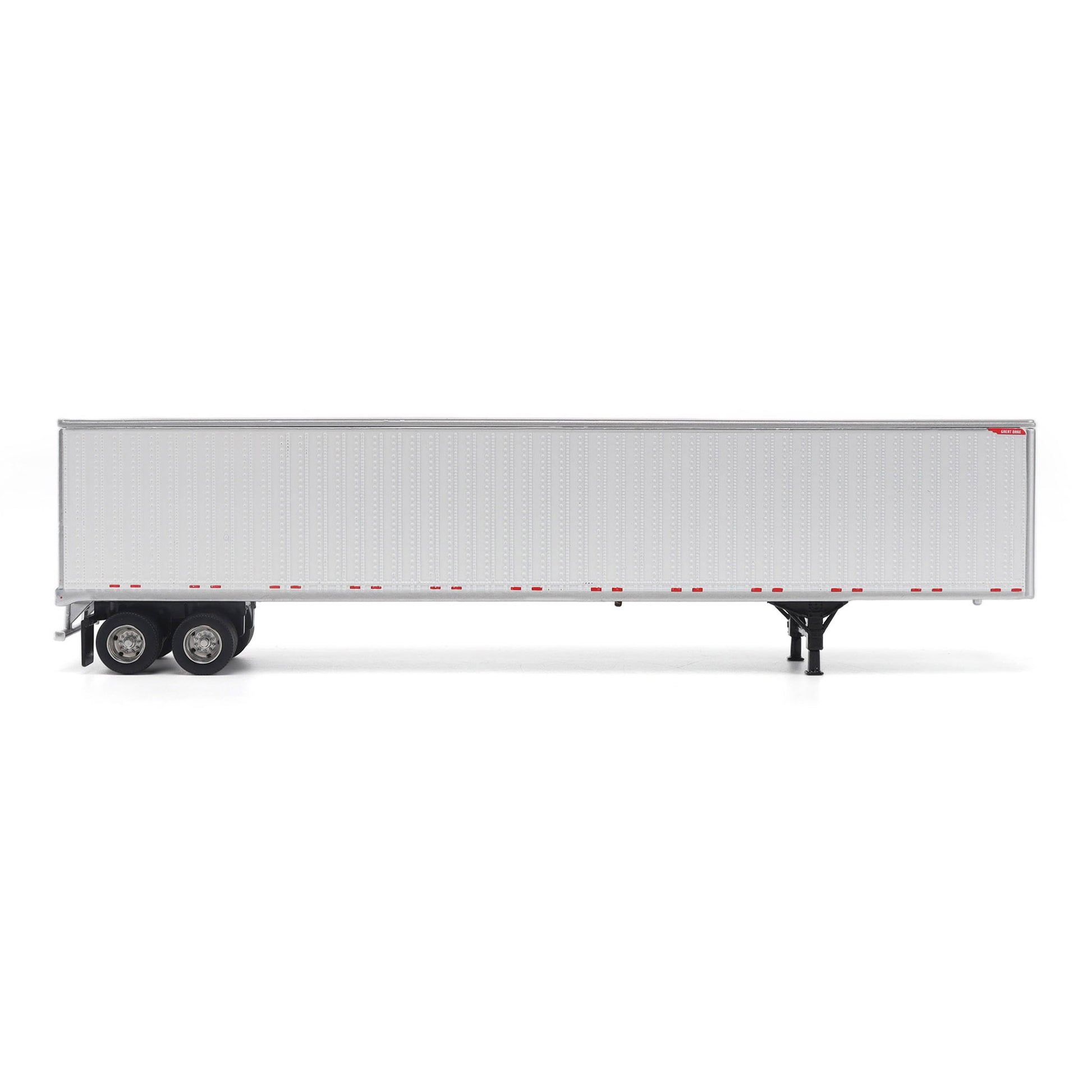 A long white Great Dane Champion semi-trailer shown in side view on a clean white studio background, with black wheels and support legs visible.