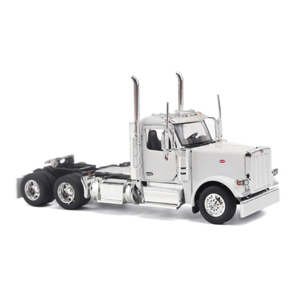 A detailed model of a classic white Peterbilt Model 589 day cab semi-truck cab with chrome exhausts, chrome wheels, and a black fuel tank and tires on a white background.
