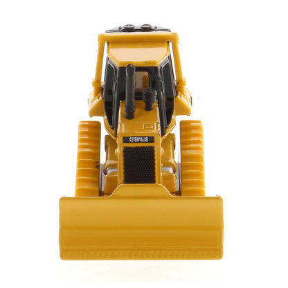 A yellow and black toy bulldozer with the Caterpillar brand logo on the front, photographed against a seamless white background.
