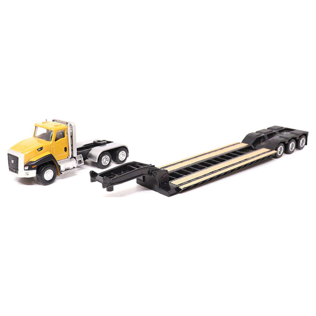 Model truck with a lowboy trailer on a white background