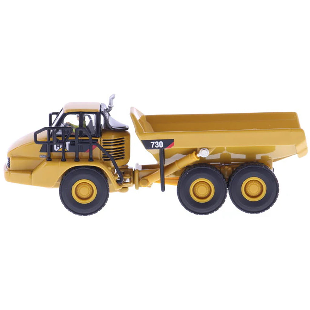 1:87 Scale Diecast and Plastic Model of a Yellow Caterpillar 730 Articulated Dump Truck on a White Background