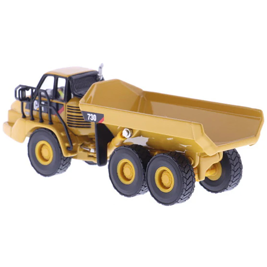 1:87 Scale Diecast and Plastic Model of a Yellow Caterpillar 730 Articulated Dump Truck on a White Background