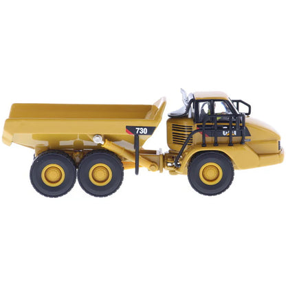 1:87 Scale Diecast and Plastic Model of a Yellow Caterpillar 730 Articulated Dump Truck on a White Background