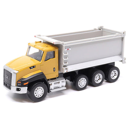 Toy CAT dump truck with yellow cab and gray bed on a white background