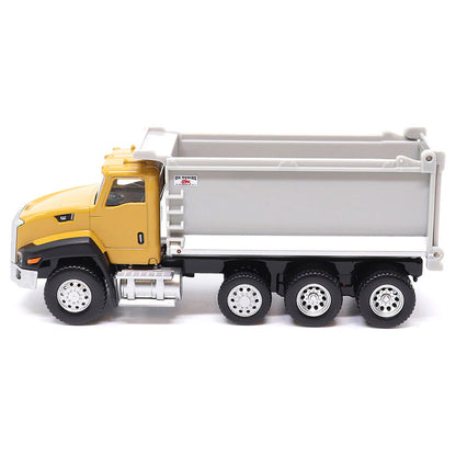 Toy CAT dump truck with yellow cab and gray bed on a white background