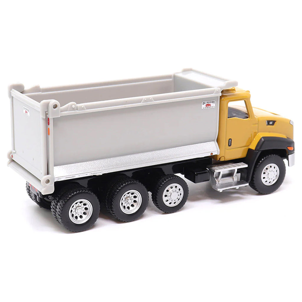Toy CAT dump truck with yellow cab and gray bed on a white background