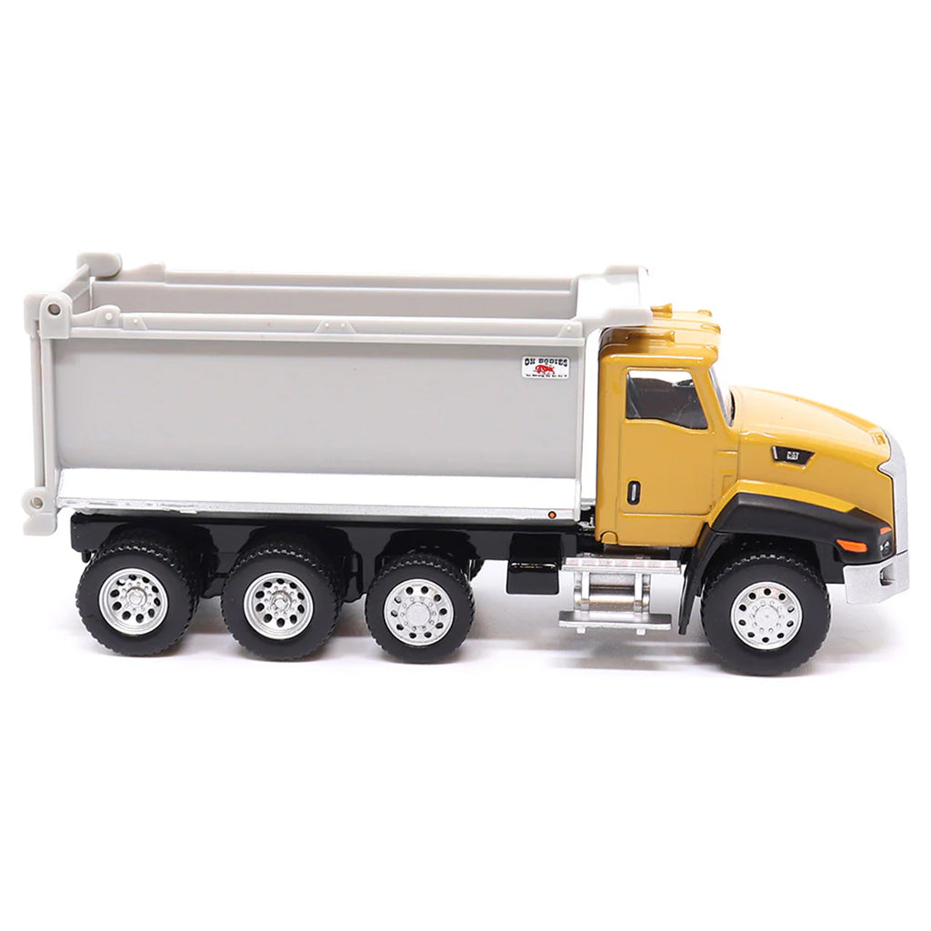 Toy CAT dump truck with yellow cab and gray bed on a white background