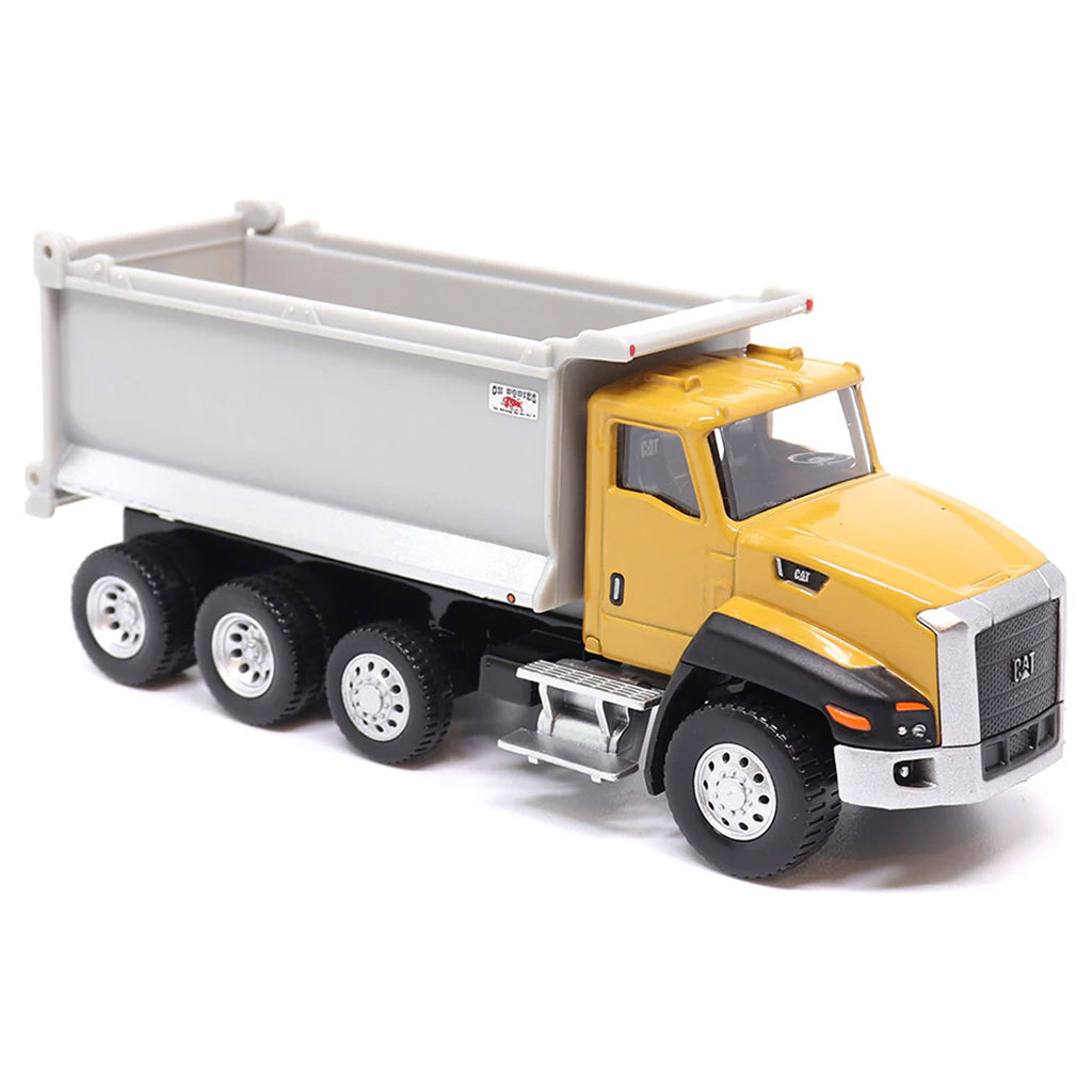 Toy CAT dump truck with yellow cab and gray bed on a white background